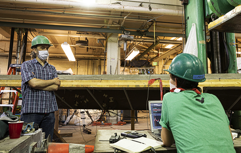 Photo of Grear demonstrating small turbine to middle schoolers