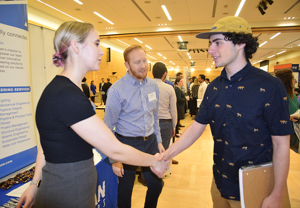 An employer shaking a student's hand