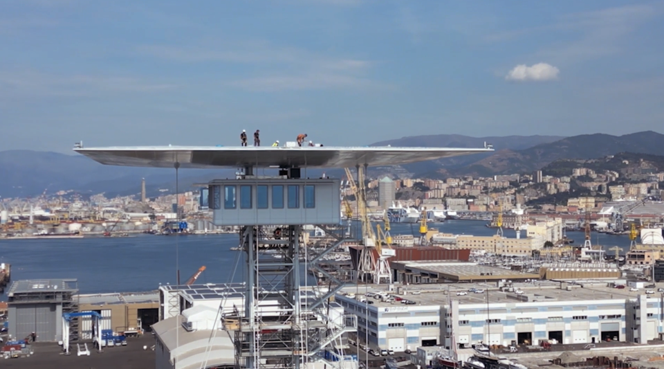 Aerial view of tower above an industrial harbor scene.