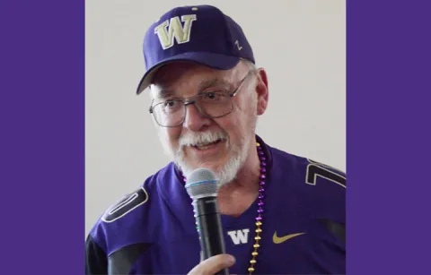 Rick Gilmore speaking while holding a microphone