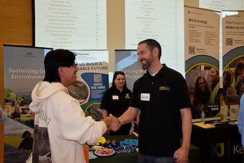 Two men shaking hands at an event