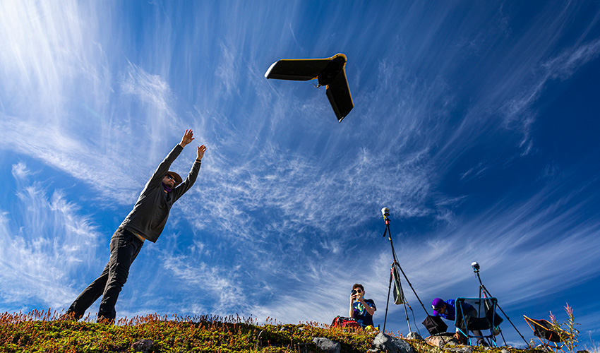 Researcher setting off a drone