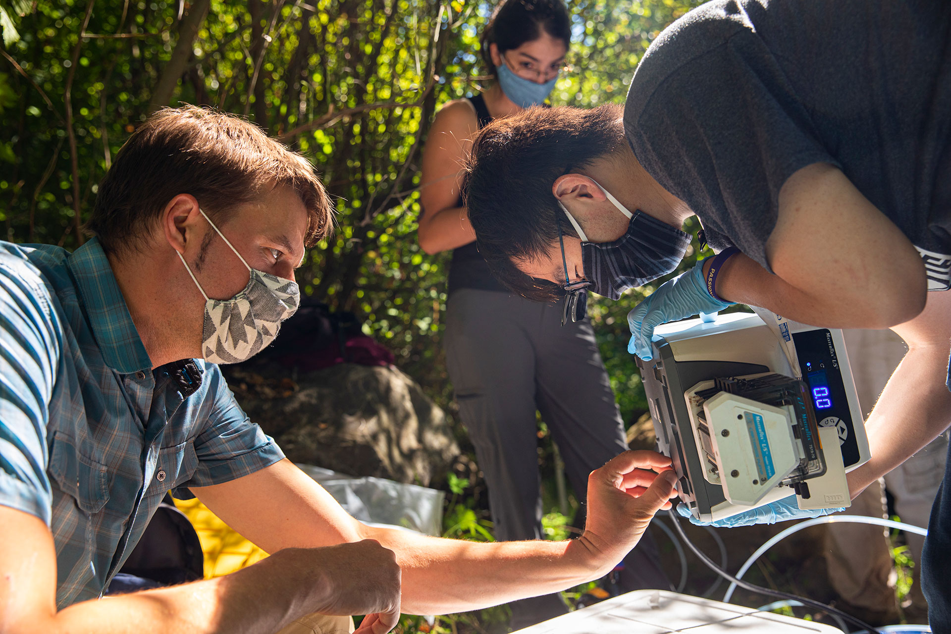 Researchers examining an electronic device