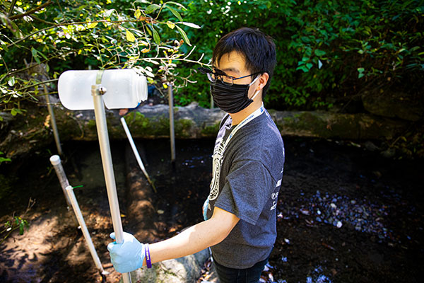 A researcher holding a plastic bottle