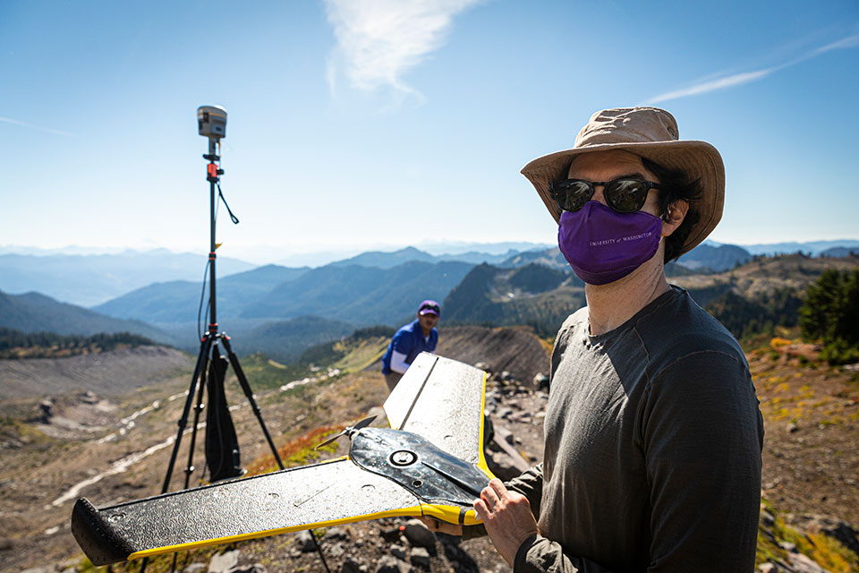 David Shean holds a fixed-wing drone