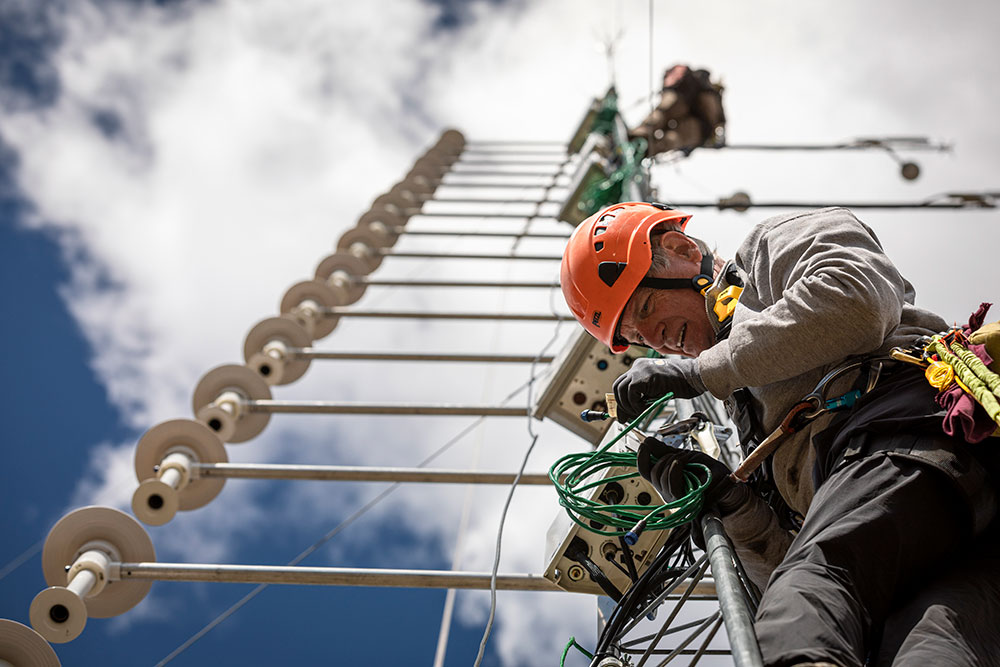 A skyward view of a 65-foot tall tower with Steve Oncley