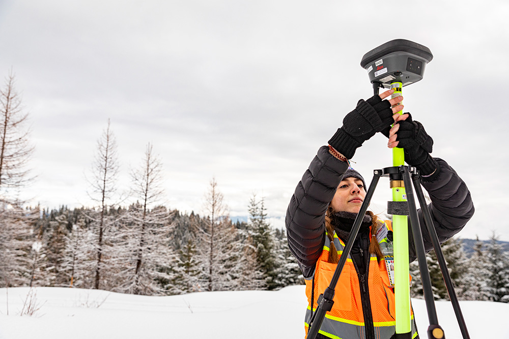 RAPID researcher  Karen Dedinsky attaches a Global Navigation Satellite System (GNSS) base station to a tripod. The equipment will be used to create GPS points that serve as ground control points for the lidar data.