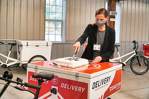 Anne Goodchild cutting a cake