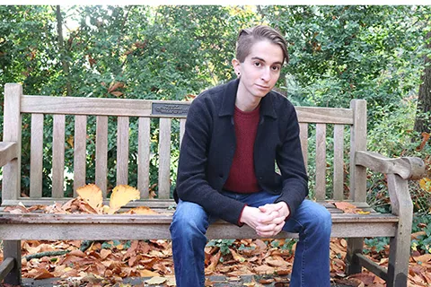 Adi Stein sitting on a bench