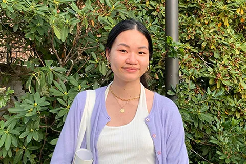 Nancy Le standing in front of some greenery