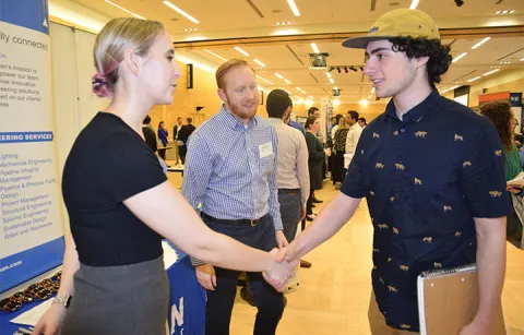 Two people shaking hands at CEE Career Fair