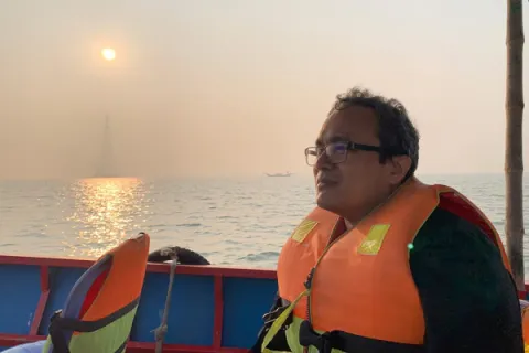 A man wearing a life jacket on a boat.